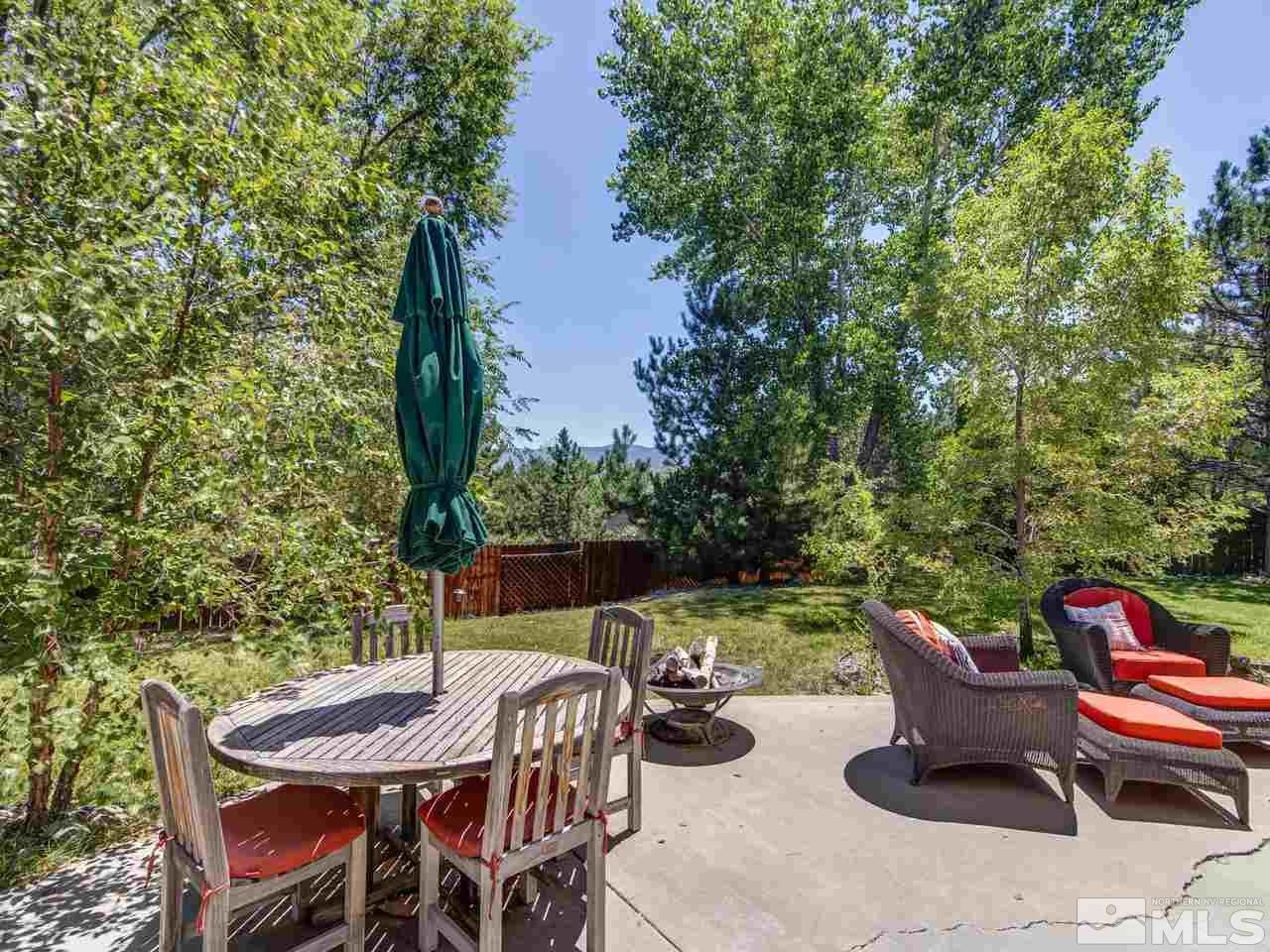 14410 Ghost Rider Drive Reno, NV 89511 - Photo 21 of 25 a view of a patio with furniture and a yard