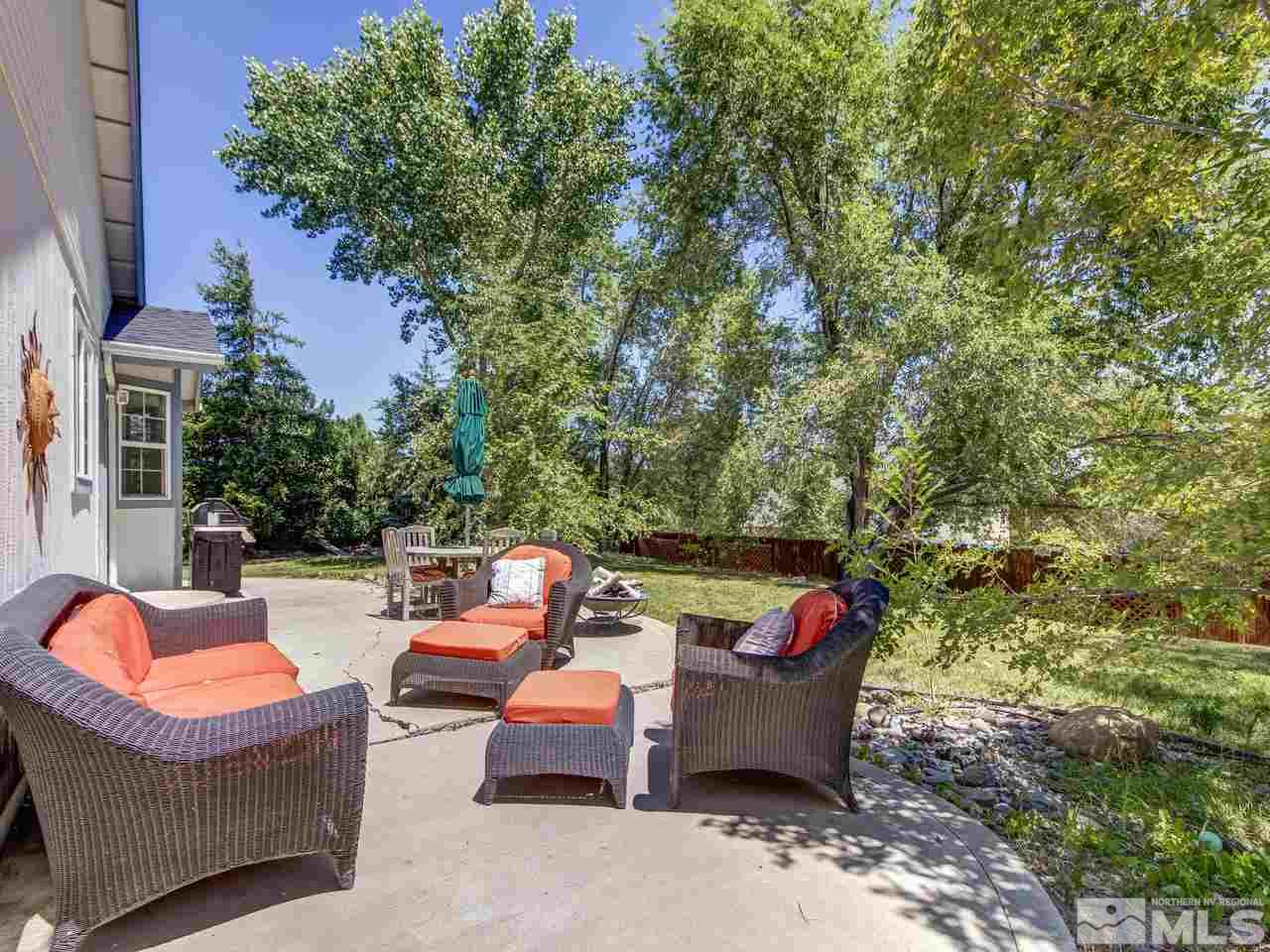 14410 Ghost Rider Drive Reno, NV 89511 - Photo 22 of 25 swimming pool with outdoor seating and trees