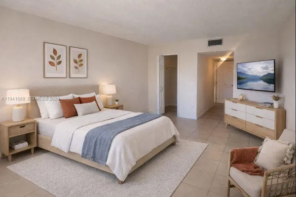 a bedroom with bed and a couch