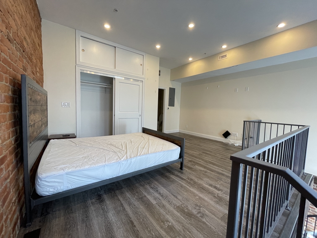 1028 Commonwealth Avenue, Unit 102 Boston, MA 02215 - Photo 6 of 11 a bed room with a bed and a television