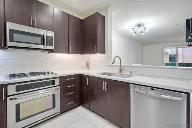 a kitchen with a sink stove and microwave