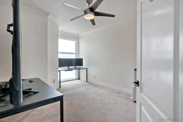 a view of workspace with a window and a ceiling fan