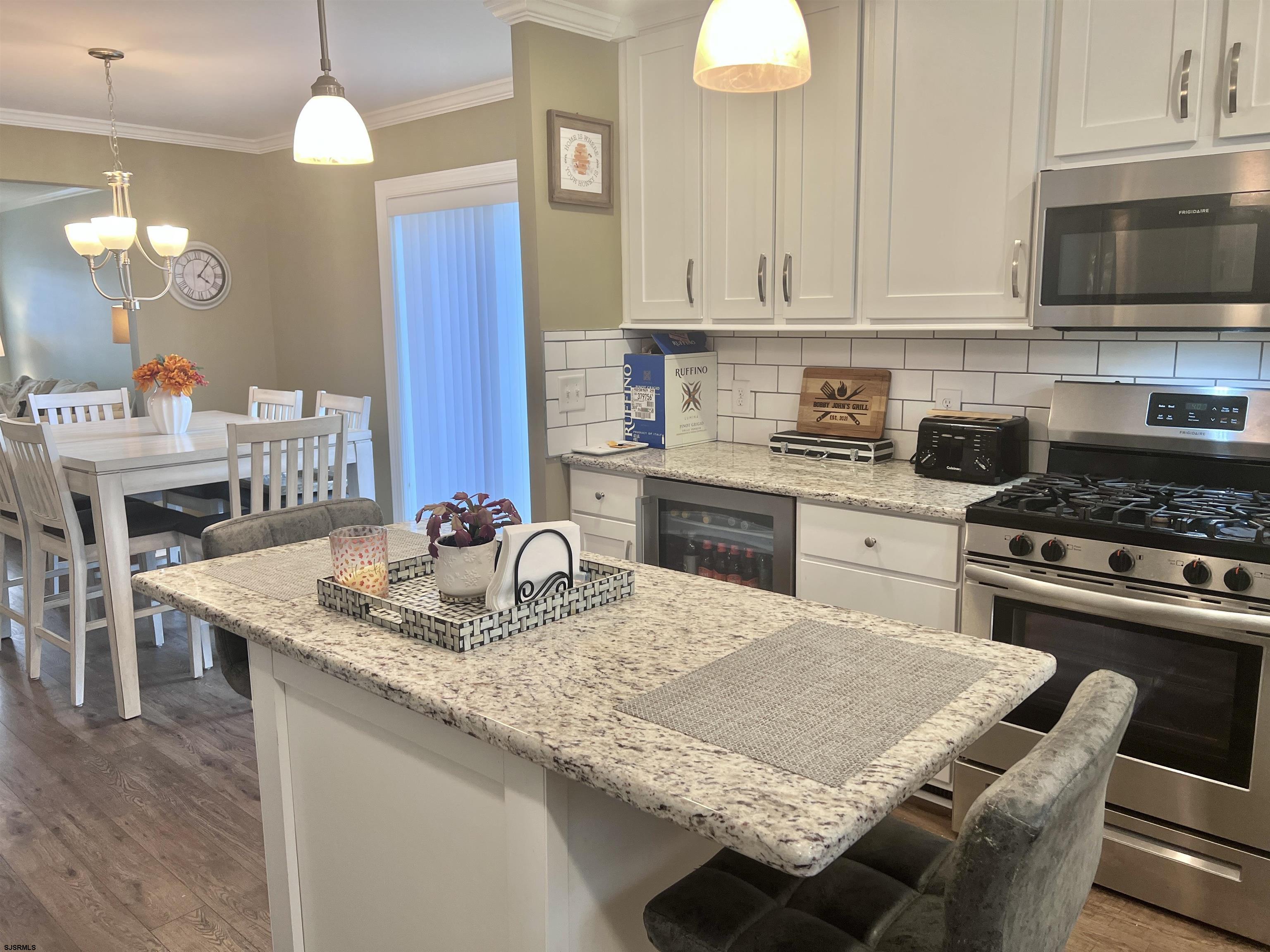 2058 Highway 9 Ocean View, NJ 08230 - Photo 11 of 37 a kitchen with a stove a sink a dining table and chairs
