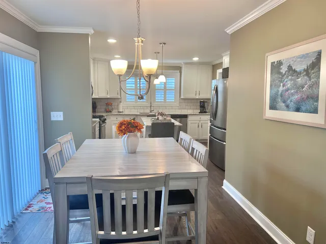 a large kitchen with a table and chairs