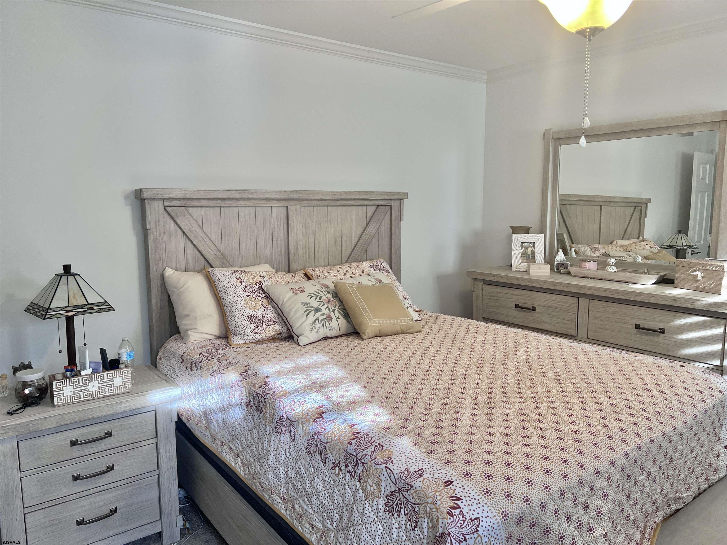2058 Highway 9 Ocean View, NJ 08230 - Photo 17 of 37 a bedroom with a bed and a chandelier