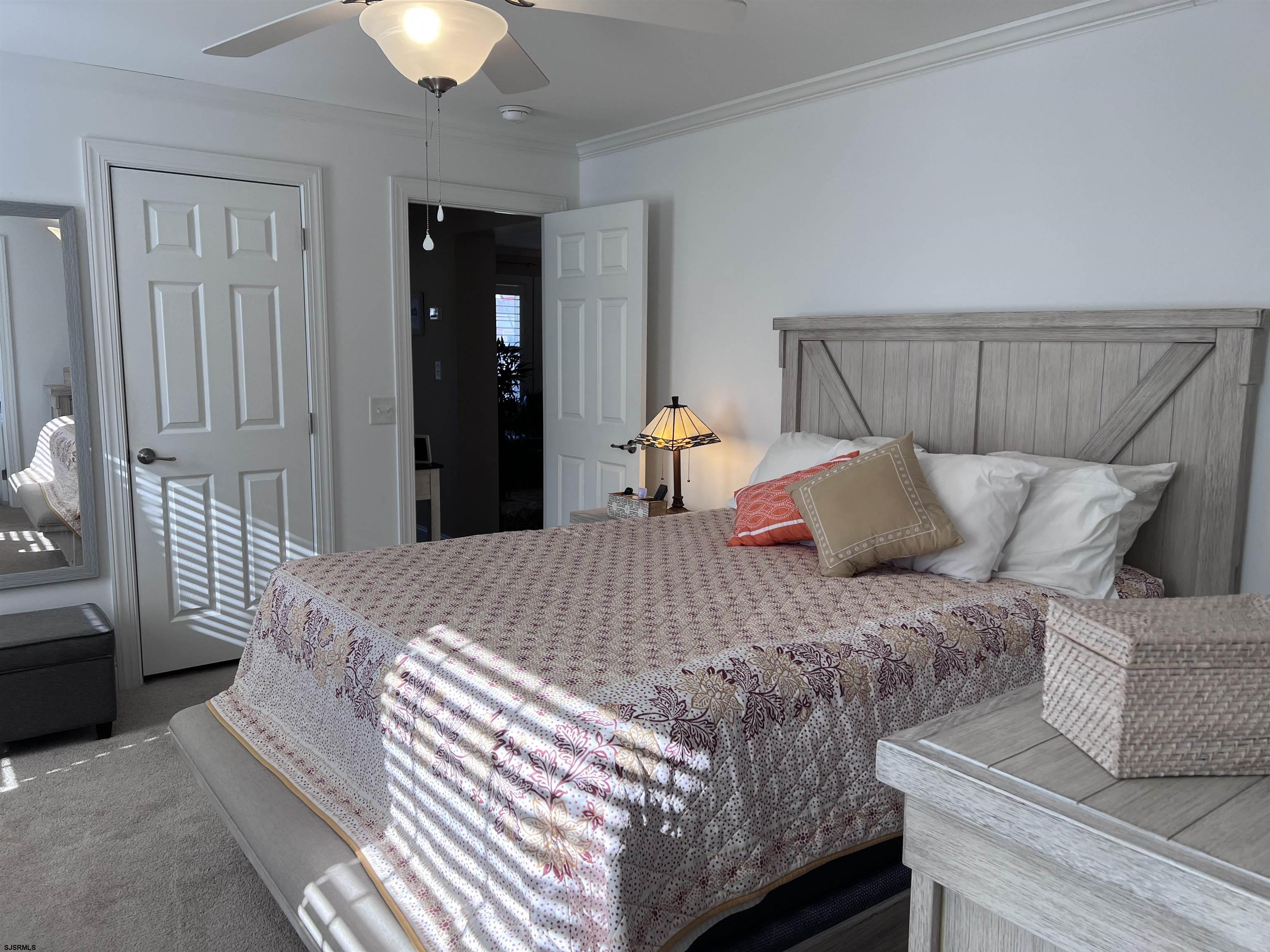 2058 Highway 9 Ocean View, NJ 08230 - Photo 19 of 37 a bed sitting in a bedroom next to a lamp