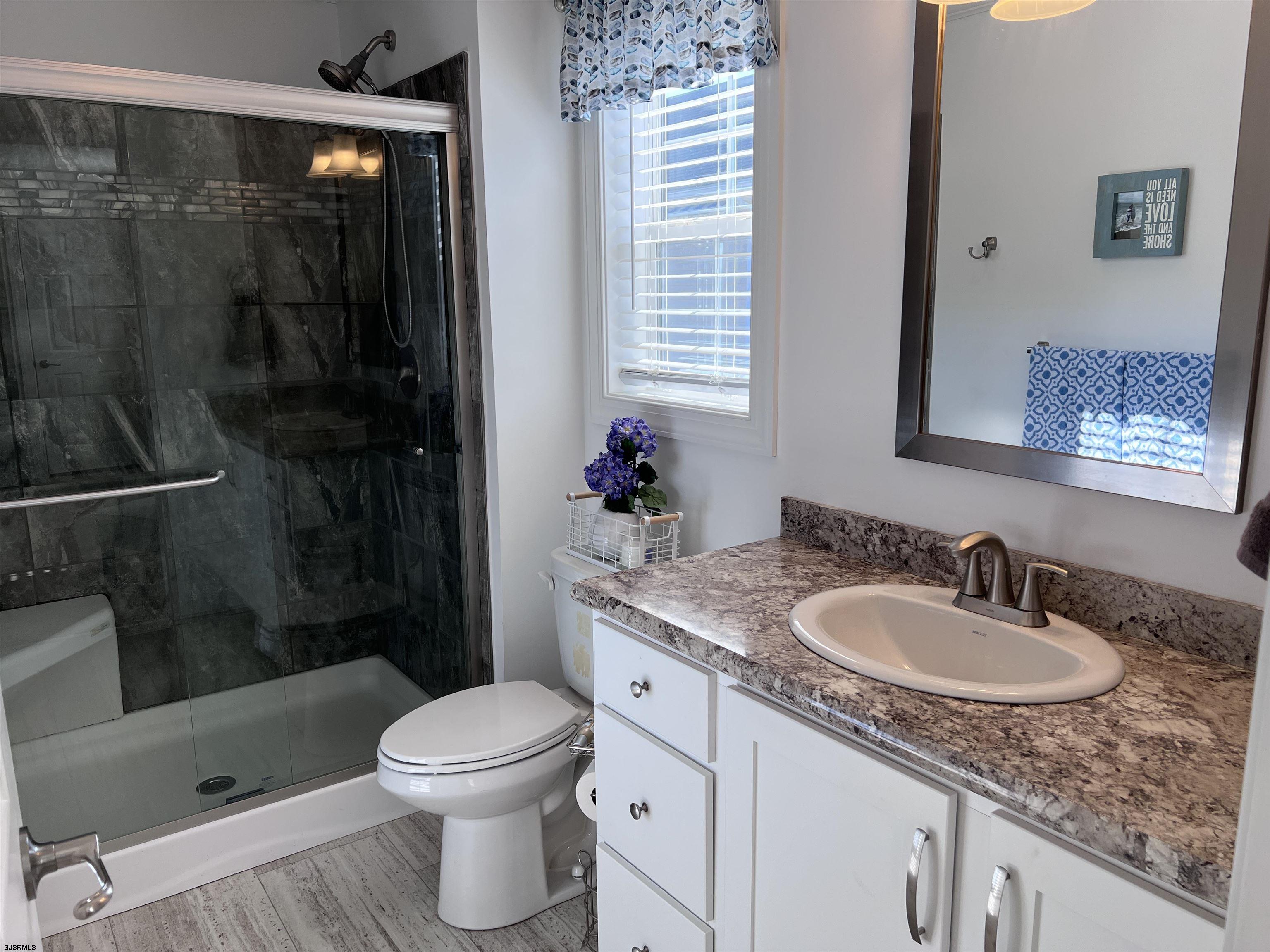 2058 Highway 9 Ocean View, NJ 08230 - Photo 20 of 37 a bathroom with a sink a toilet and shower