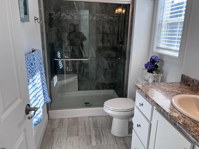 a bathroom with a sink toilet and shower