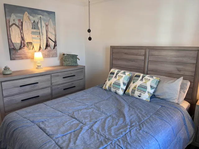 a large bed sitting in a bedroom next to a window