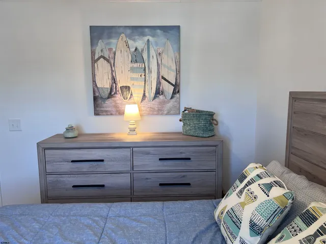 a view of room with cabinet and a bed