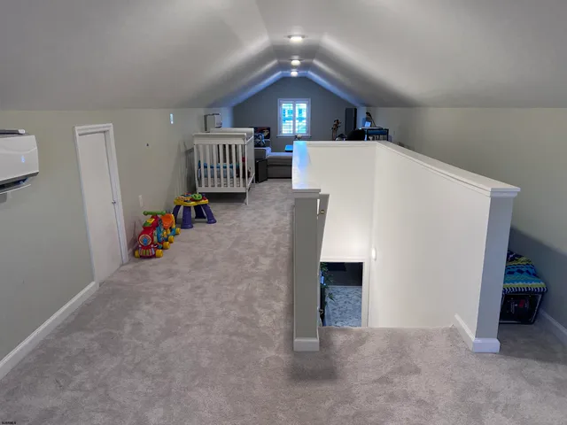 a view of a livingroom with stairs and furniture