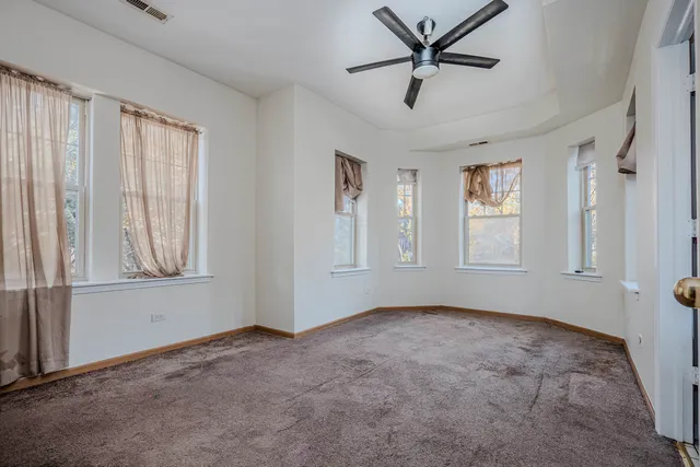 a view of a livingroom with a ceiling fan and window
