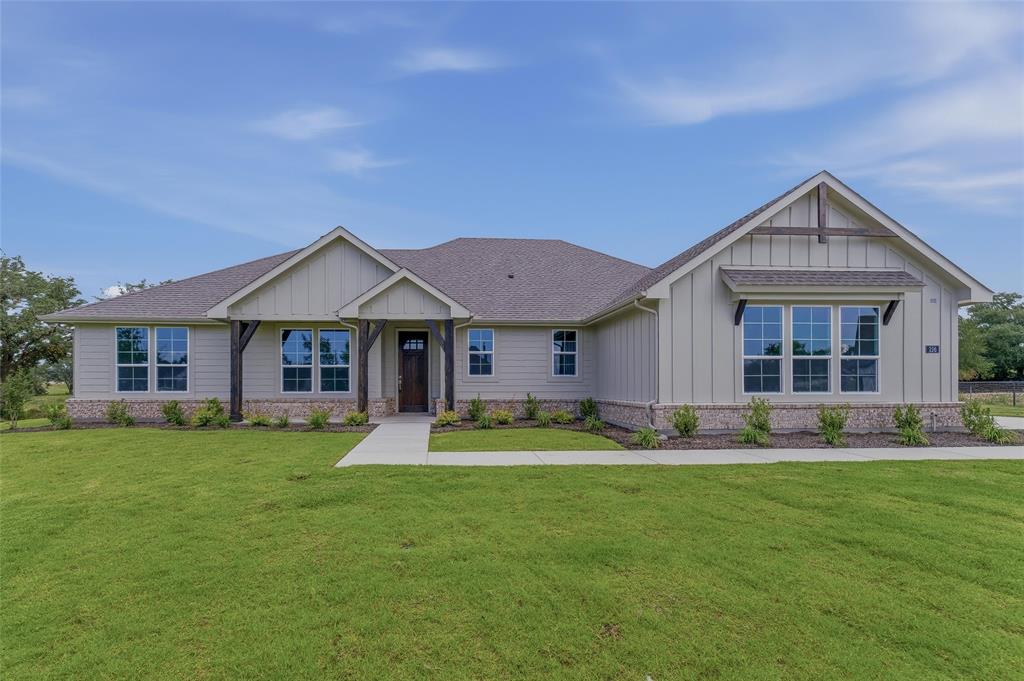 156 Oak Grv Way Springtown, TX 76082 - Photo 4 of 25 Ranch-style residence featuring a light-toned board and batten facade and stone detailing