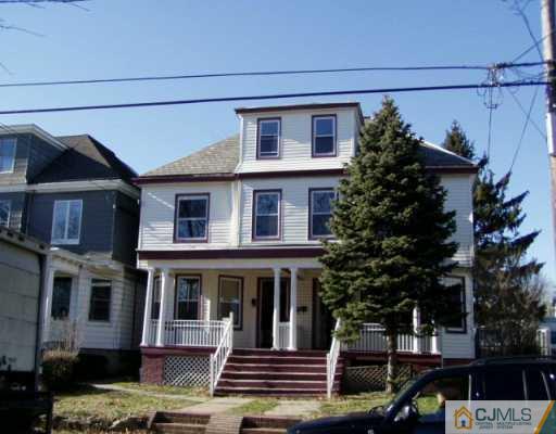 225-27 Rector Street Perth Amboy, NJ 08861 - Photo 1 of 6 a front view of a house with garden