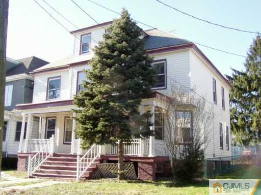 225-27 Rector Street Perth Amboy, NJ 08861 - Photo 2 of 6 a front view of a house with a yard