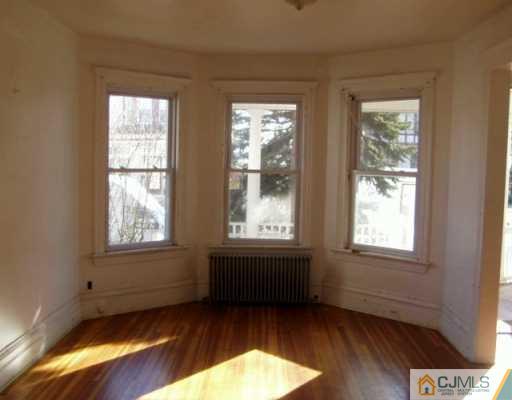 225-27 Rector Street Perth Amboy, NJ 08861 - Photo 4 of 6 a view of an empty room and window