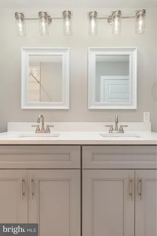 a bathroom with sink mirror and