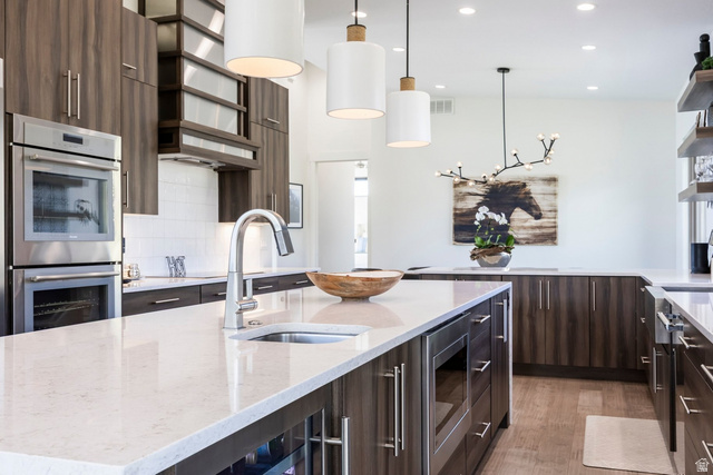 140 West Vista Road Kamas, UT 84036 - Photo 24 of 101 Spacious kitchen featuring a large island with an undermount sink, integrated microwave, and beverage cooler