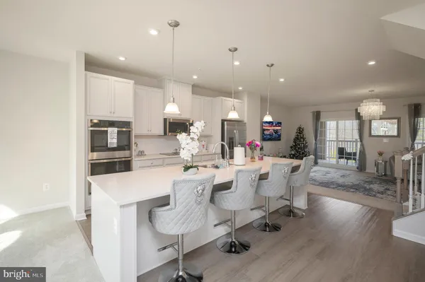 a large kitchen with a table and chairs