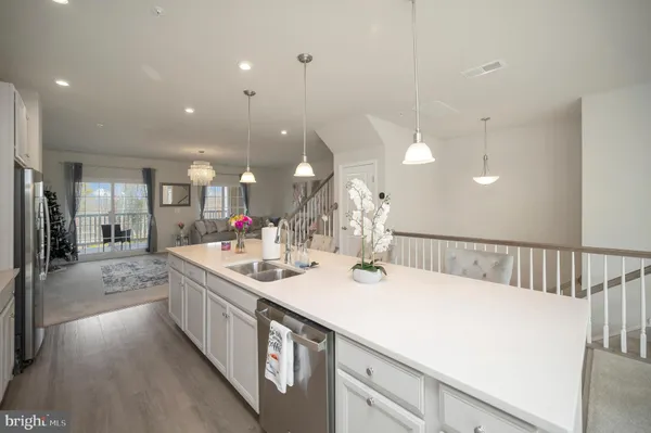 a large kitchen with kitchen island a sink stainless steel appliances and cabinets