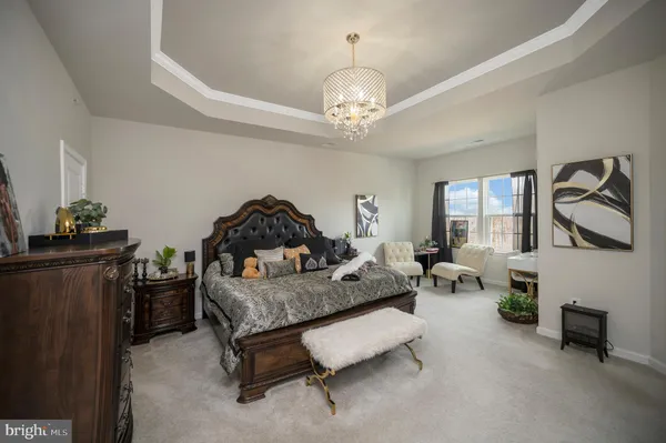 a bedroom with furniture and a chandelier