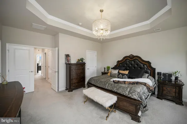 a bedroom with a bed and a chandelier