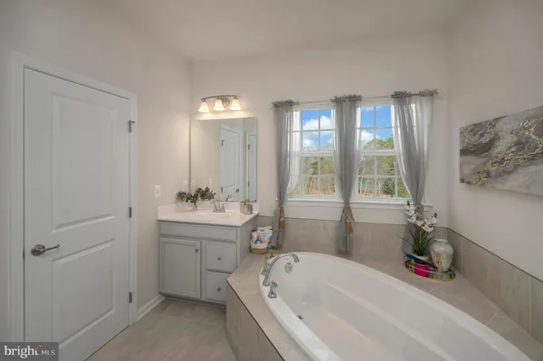 a bathroom with a bathtub and a sink