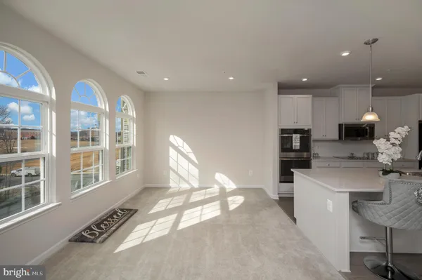 a kitchen with stainless steel appliances granite countertop a sink and a stove