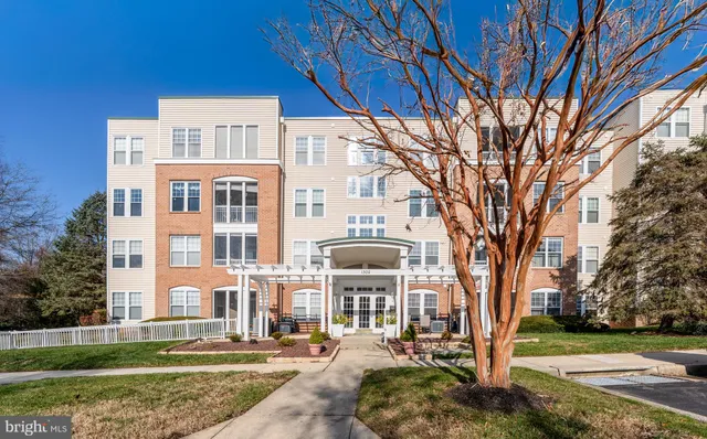 a front view of a building with a yard