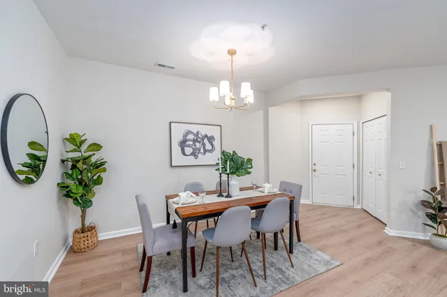 a view of a dining room with furniture and chandelier