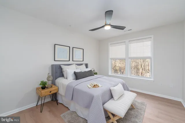 a bed room with a bed and a chair