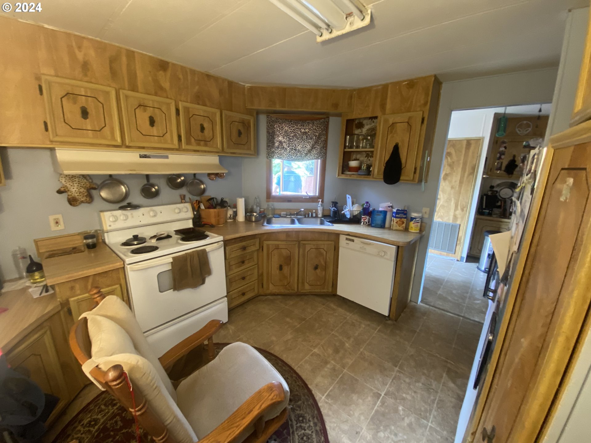 237 Waite Street Eugene, OR 97402 - Photo 7 of 17 a white kitchen with stainless steel appliances granite countertop a stove a sink and a refrigerator