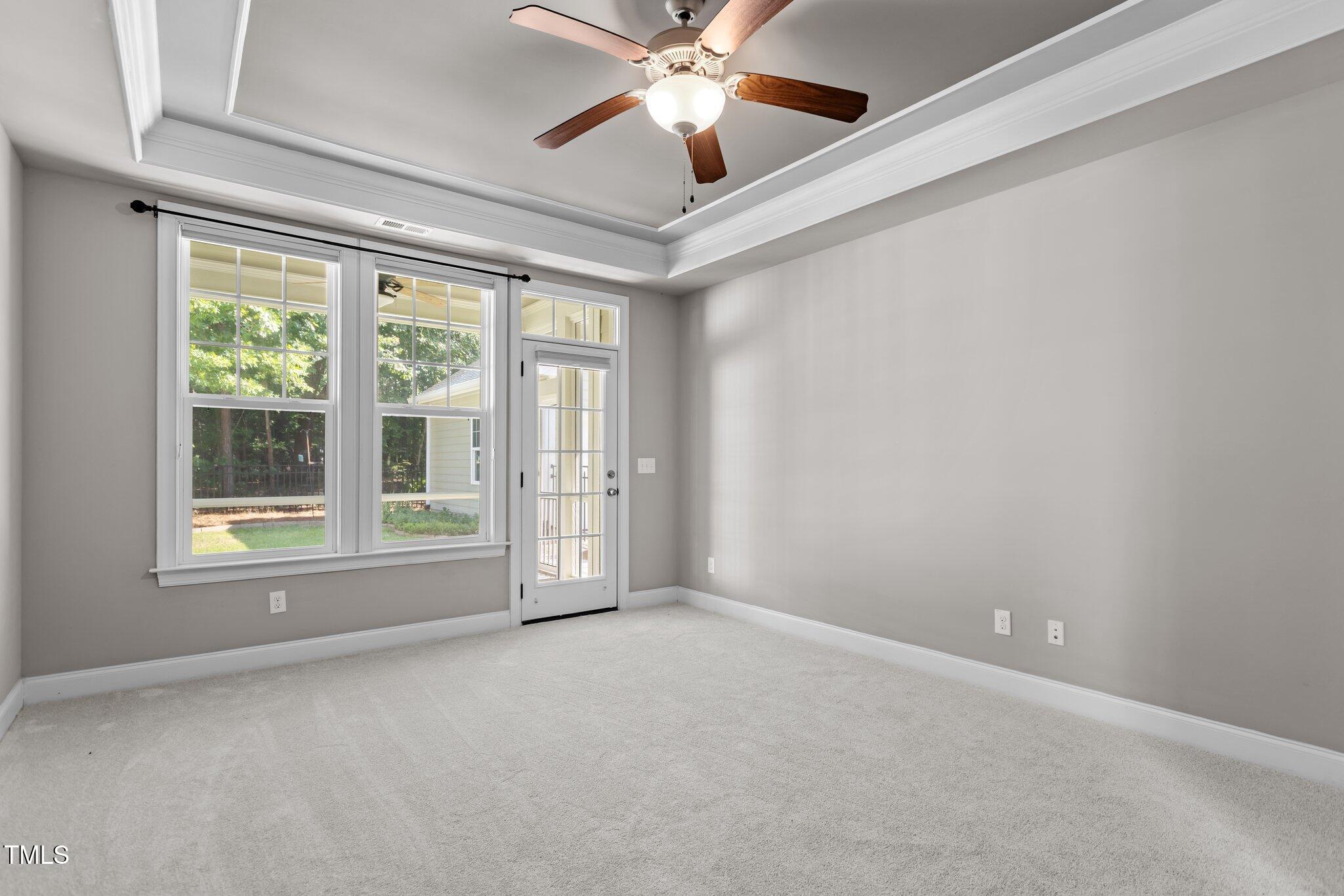 511 Mill Hopper Lane Apex, NC 27502 - Photo 22 of 53 an empty room with windows and ceiling fan