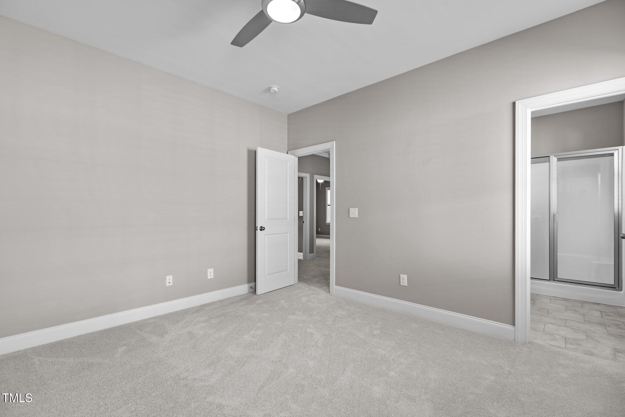 511 Mill Hopper Lane Apex, NC 27502 - Photo 29 of 53 a view of an empty room with a ceiling fan