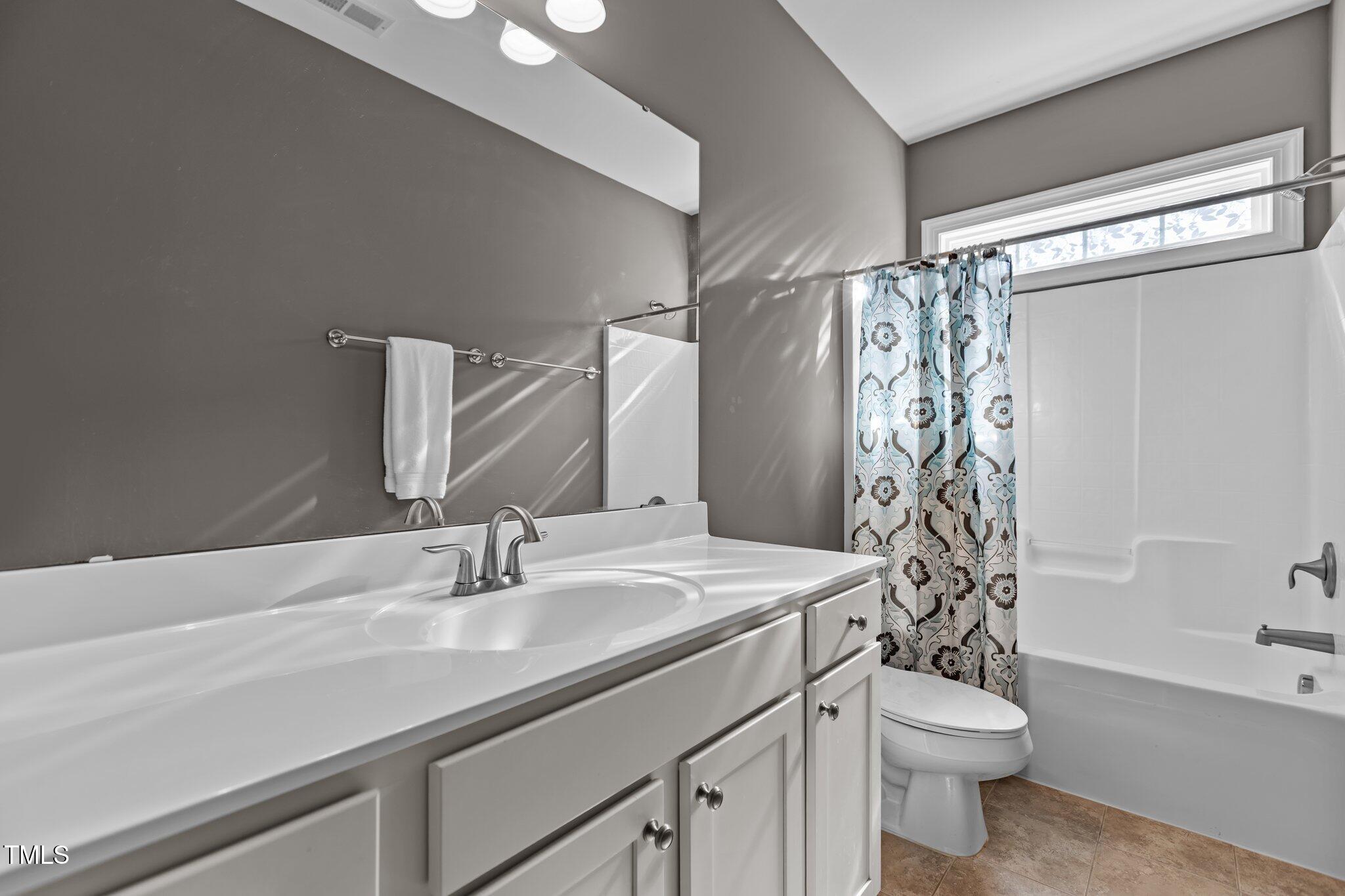 511 Mill Hopper Lane Apex, NC 27502 - Photo 38 of 53 a bathroom with a sink a toilet and shower