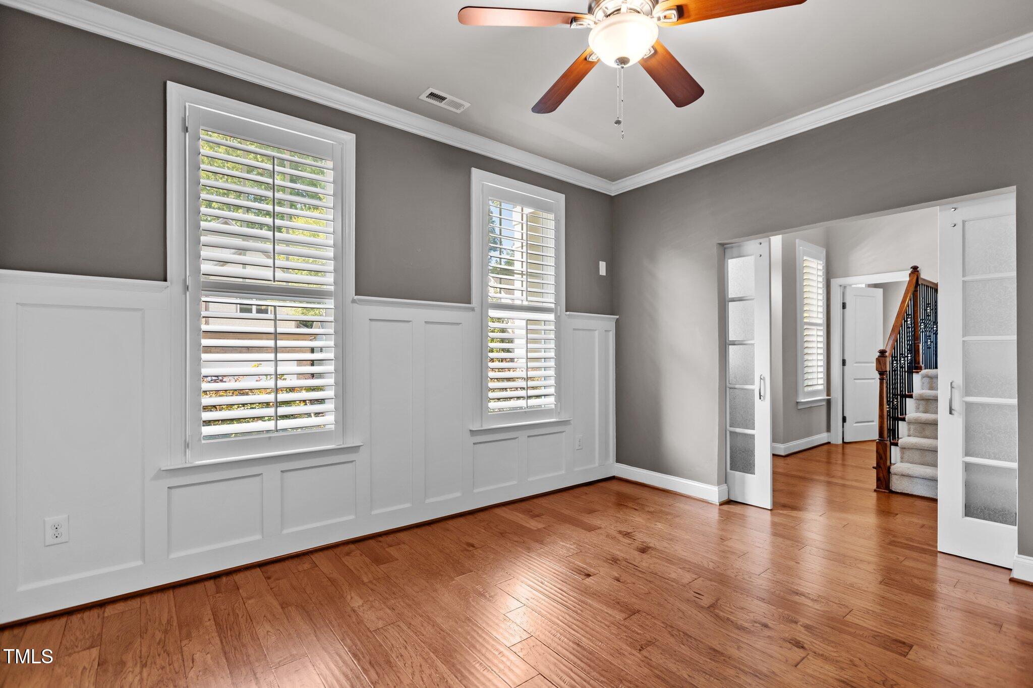 511 Mill Hopper Lane Apex, NC 27502 - Photo 8 of 53 a view of an empty room with window and wooden floor