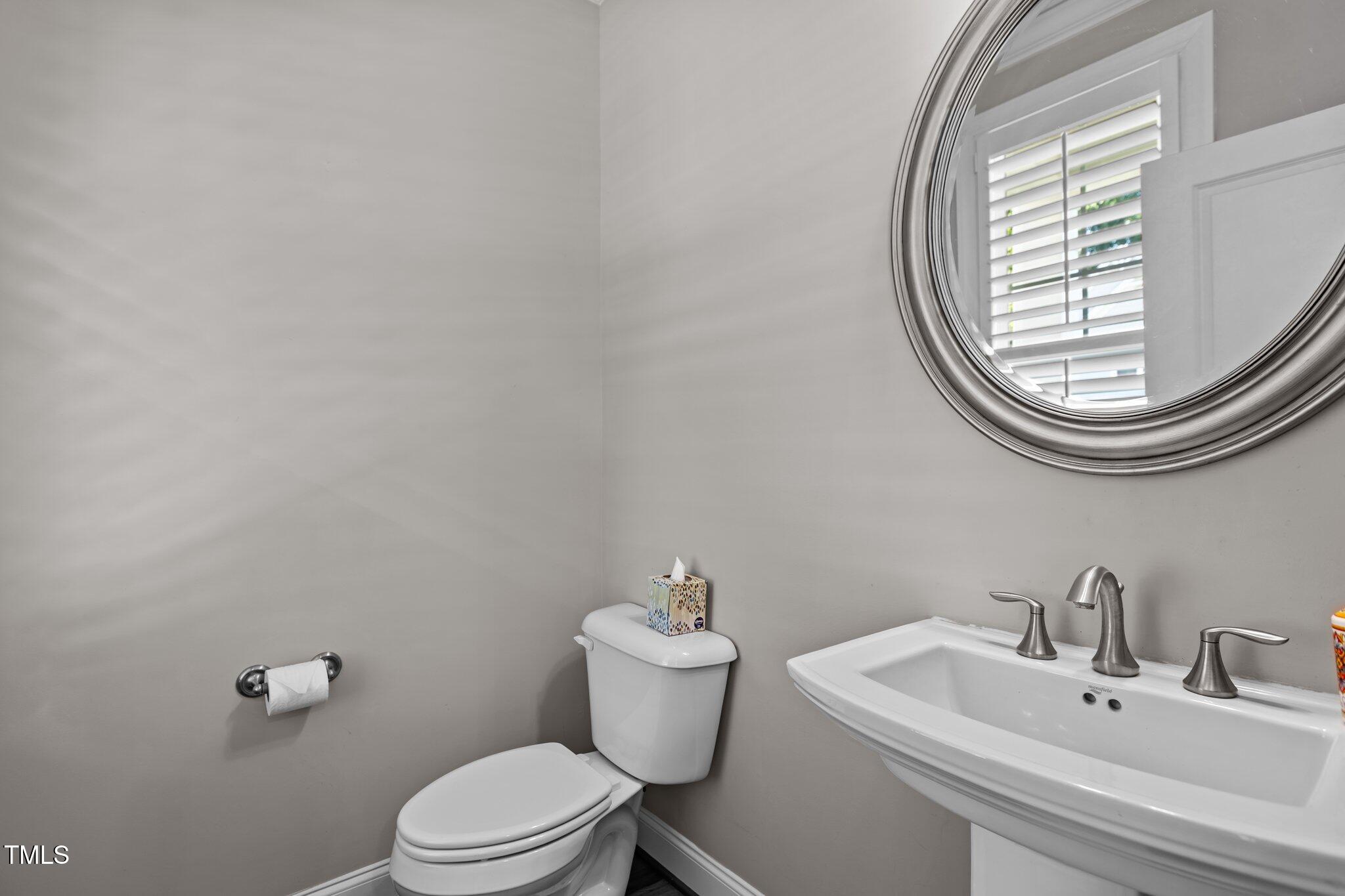 511 Mill Hopper Lane Apex, NC 27502 - Photo 9 of 53 a bathroom with a sink and a mirror