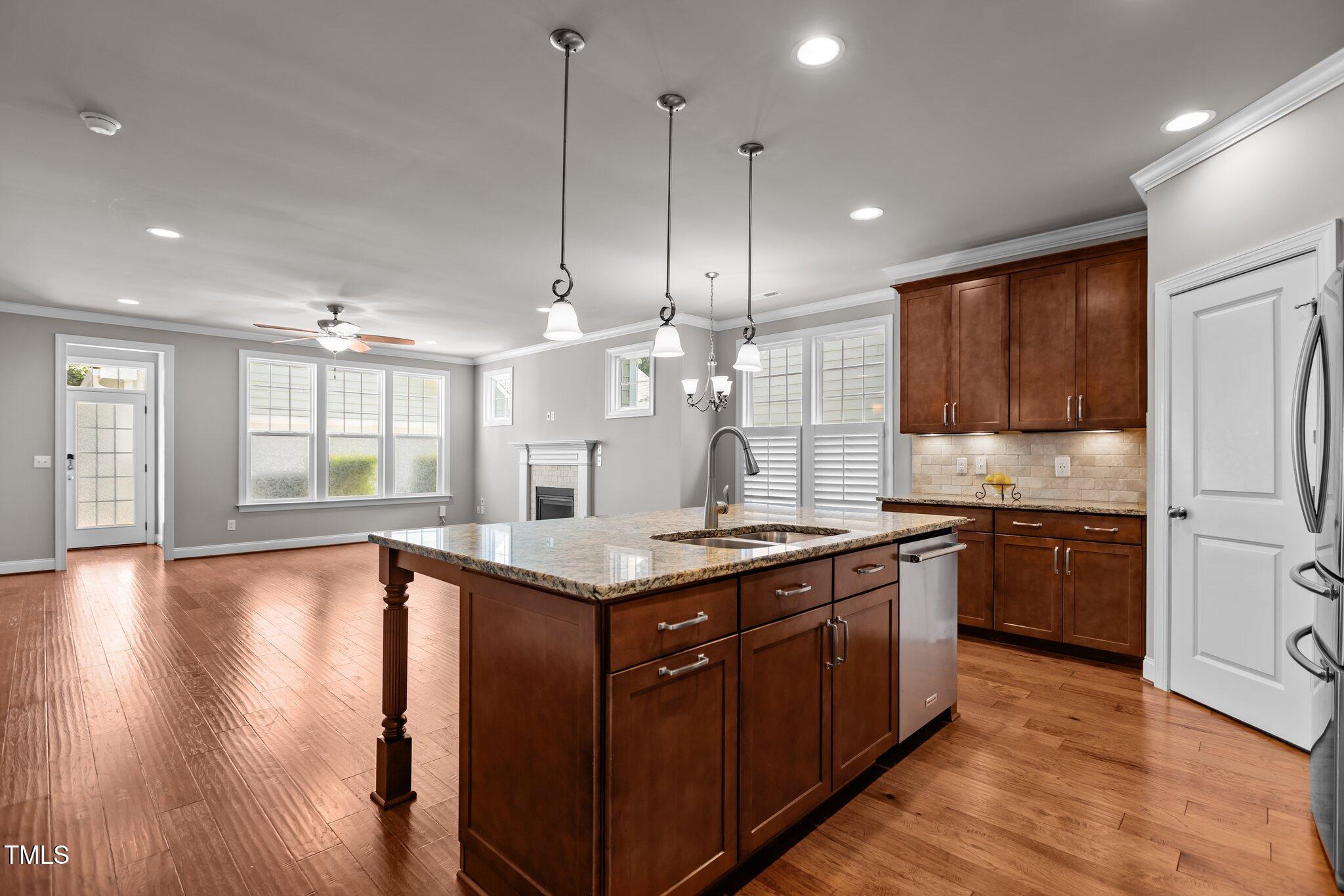 511 Mill Hopper Lane Apex, NC 27502 - Photo 10 of 53 a large kitchen with stainless steel appliances granite countertop a stove and a wooden floors