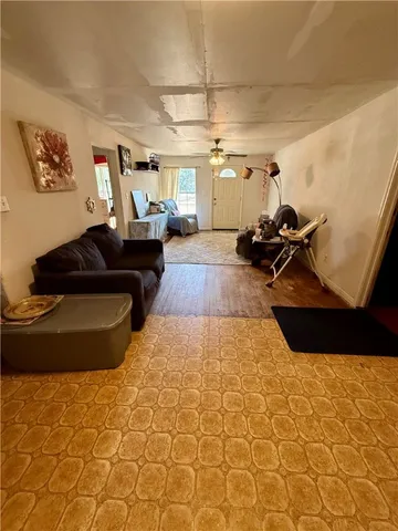 a living room with couch and a mirror