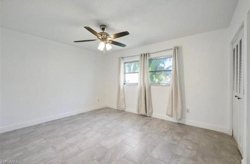 1948 46th Street Southwest Naples, FL 34116 - Photo 8 of 14 Room with light-toned tiled flooring, white walls, and a ceiling fan with integrated lighting