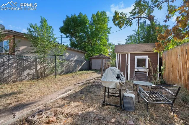 a view of a house with backyard and sitting area