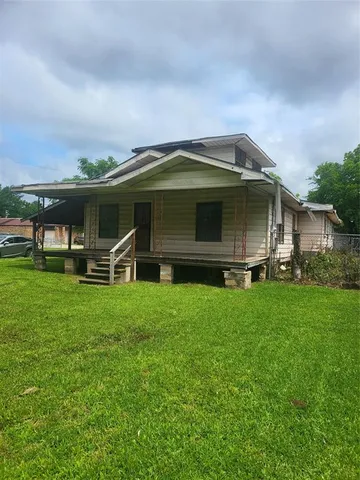 a front view of house with yard and green space