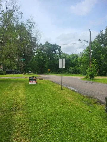 a swimming pool with lots of tress in front of it