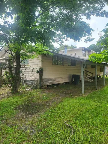 a backyard of a house with table and chairs