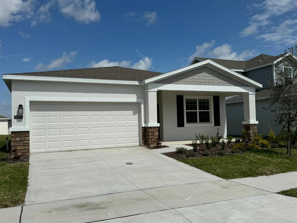 1029 Holden Way Eagle Lake, FL 33839 - Photo 2 of 22 a front view of a house with garden