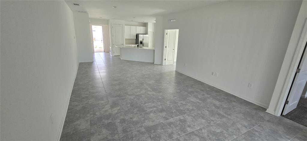 1029 Holden Way Eagle Lake, FL 33839 - Photo 7 of 22 a view of a hallway with a livingroom and a bathroom sink