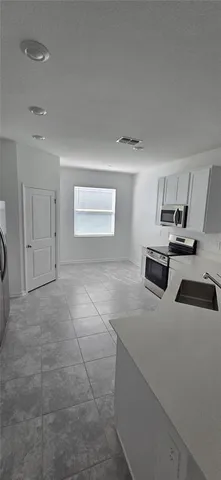 a kitchen with stainless steel appliances a refrigerator and a sink