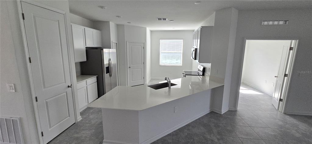 1029 Holden Way Eagle Lake, FL 33839 - Photo 9 of 22 a kitchen with stainless steel appliances a refrigerator and a sink