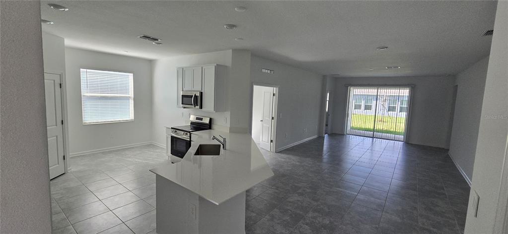 1029 Holden Way Eagle Lake, FL 33839 - Photo 10 of 22 a hallway with wooden floor and cabinet
