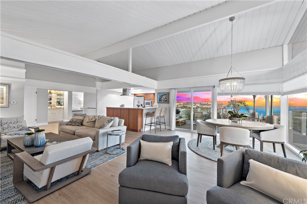 317 Monarch Bay Drive Dana Point, CA 92629 - Photo 19 of 26 a living room with patio furniture and a chandelier